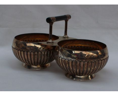 A Victorian silver twin sugar basin with a T bar handle, each basin with a gadrooned body on a spreading foot, London, 1886, 