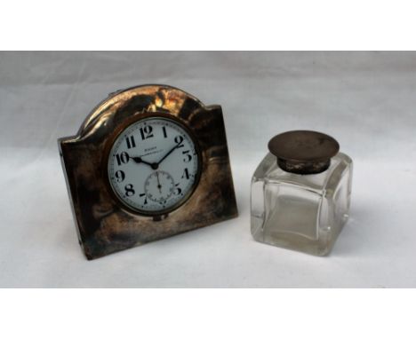 A George V silver easel desk clock, the enamel dial with Arabic numerals and a seconds subsidiary dial inscribed 8 Days Walke