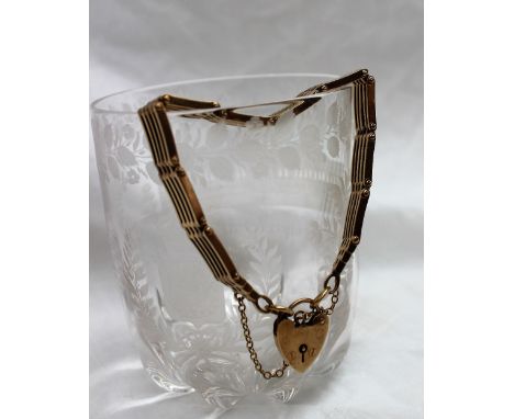 A 9ct yellow gold lady's gate bracelet with a padlock clasp, approximately 27 grams