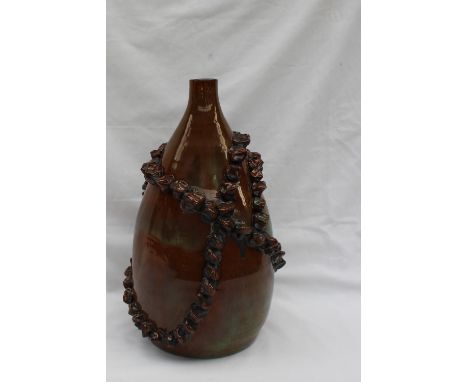 A John Hughes Pottery lamp base, of vase shape with applied decoration to a mottled brown and green base, signed to the base 