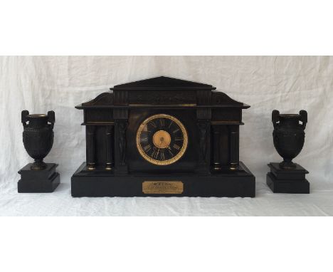 An impressive Edwardian black slate mantle clock of architectural design with a portico, moulded frieze, corinthian and figur