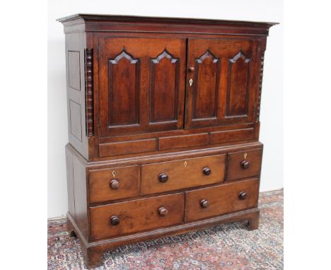 An 18th century oak mule chest, the rectangular moulded top above a pair of ogee arched panelled doors, the base with an arra