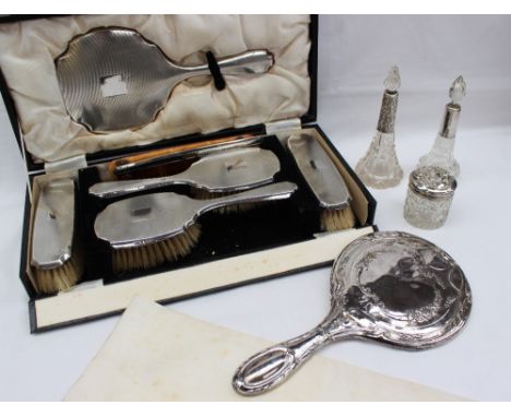 A George V silver backed dressing table set, comprising a pair of hair brushes, clothes brushes, hand mirror and comb, Birmin