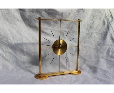 A Jaeger-Le Coultre perspex and gilt metal eight day mantle clock of rectangular form, on circular feet, 20cm high x 17.5cm w