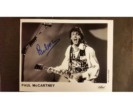 POP MUSIC, signed promotional photo by Paul McCartney, half-length playing bass, 10 x 8, with press release for 1993 CD relea