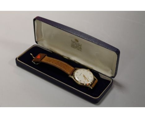 GARRARD GENTS 9CT GOLD CASED MANUAL WIND WRIST WATCH, white dial with gold Arabic numeral markers and sub dialCuttlestones of