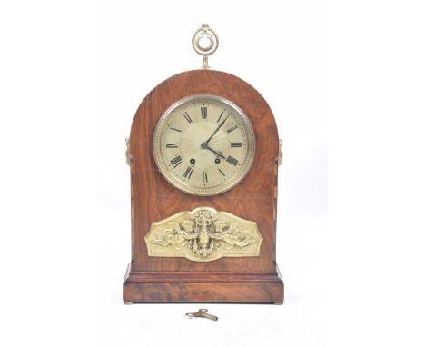A late 19th Century French mantle clock
The domed architectural case inlaid with various wood marquetry panels, further appli