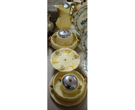 A Clarice Cliff Celtic Harvest pattern jug, moulded in relief with wheat sheaves,  the handle encrusted with fruit, 28cm high