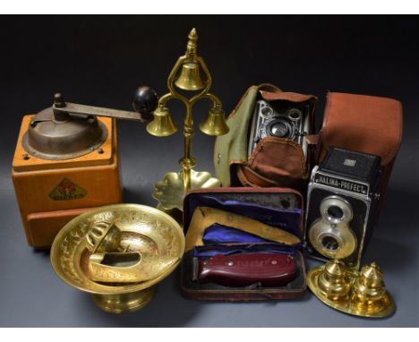 A brass horse head ornament, three bells, mounted on brass stand; other brassware; a coffee grinder; a Kodak box camera; anot