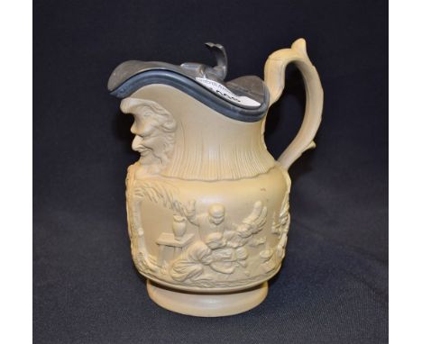 A Victorian drabware relief moulded jug, The Card Game, with monkeys in Indian headdress playing cards, mask to spout, pewter