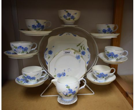 A Paragon tea set for six decorated with blue flowers comprising sandwich plate, cream jug, sugar bowl, cups and saucers