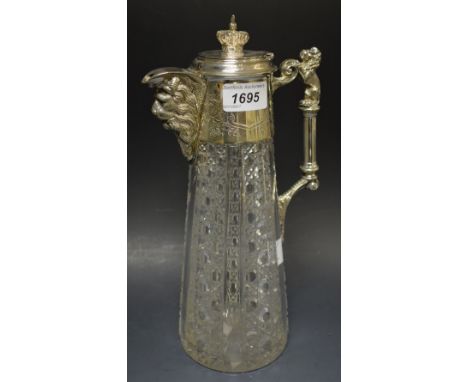 An Edwardian cut glass claret jug, EPNS mounted with lion scroll handle, lion mask spout and coronet finial