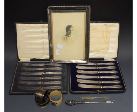 A set of six silver hafted butter knives, cased, Birmingham 1915; another, Sheffield 1919; a silver hafted button hook, a pho