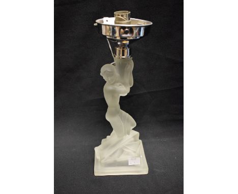 An Art Deco frosted glass figural table lamp, moulded as a scantily clad female, kneeling, on a stylised geometric rocky out 