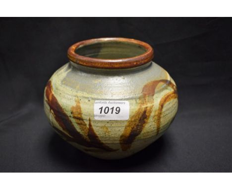 A Studio Pottery Leach type stoneware compressed ovoid vase, painted with a band of leafy fronds in shades of brown on a mott