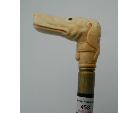 A bone carved walking stick formed as a dog. 94.5 cm long.