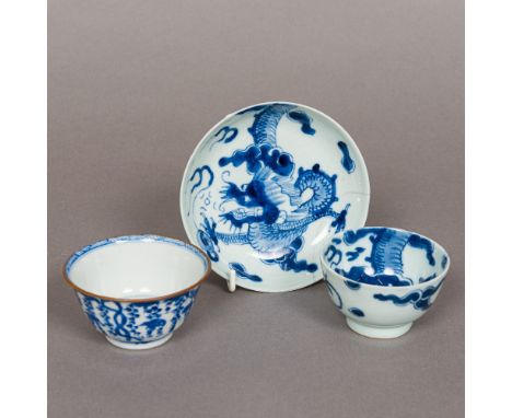 An 18th century Chinese blue and white porcelain tea bowl and saucer, each piece decorated with a dragon chasing a flaming pe