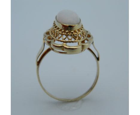 An unmarked gold and opal ring. Ring size M/N.