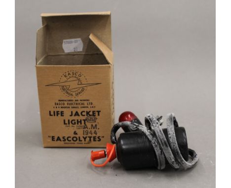 A 1944 boxed life jacket light.