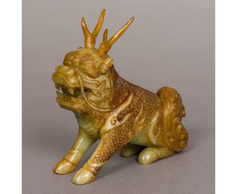 A Chinese jade carving of a Qilin, typically modelled.  15.5 cm high. Provenance: From a local private collection.