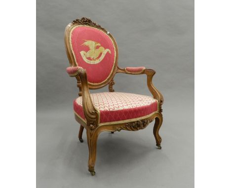 A tapestry covered 19th century walnut open armchair. 62 cm wide.