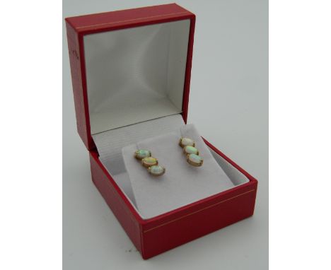 A pair of 9 ct gold and opal earrings. 1.2 cm high.