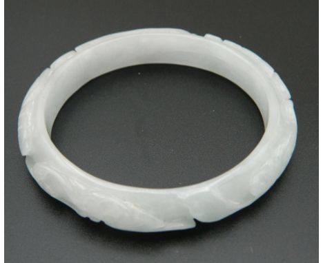 A white jade bangle. 7 cm diameter.