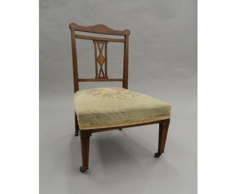 A tapestry covered Edwardian inlaid rosewood nursing chair. 50 cm wide.
