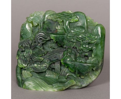 A Chinese jade boulder carving, formed as a sagely figure, seated amongst trees and pagodas with a boat in the foreground. 13