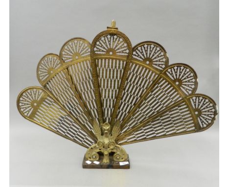 A brass folding fire screen in the form of a phoenix. 59 cm high.