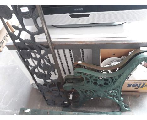A pair of garden cast bench ends and a cast insert 