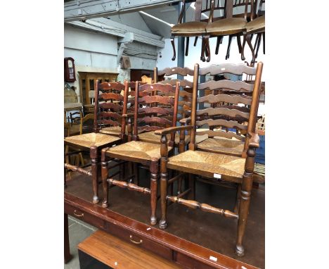 A set of six rush seated ladder back chairs. 