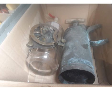 A box containing a soda syphon, vintage pump, and reproduction compass 