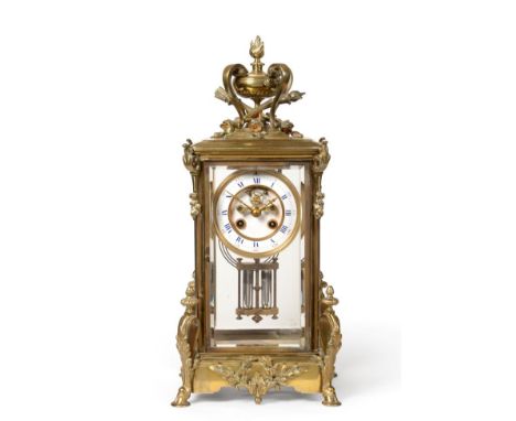 A Brass Four Glass Striking Mantel Clock, circa 1890, urn shaped finial, bevelled glass panels, scroll and floral corner moun