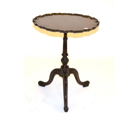 A Carved Mahogany Tripod Table, in George II style, the moulded top raised on a turned and stop-fluted support with acanthus 