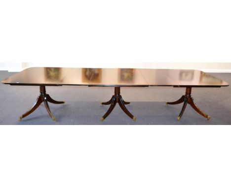 A Mahogany Triple Pillar Dining Table, 20th century, in George III style, of rounded rectangular form with reeded edge, three