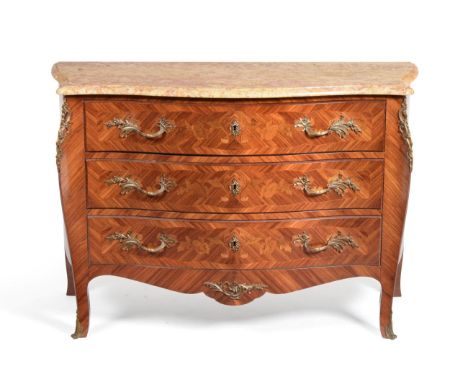 A French Louis XV Style Tulipwood and Floral Marquetry Serpentine Shaped Commode, 20th century, the yellow marble top above t