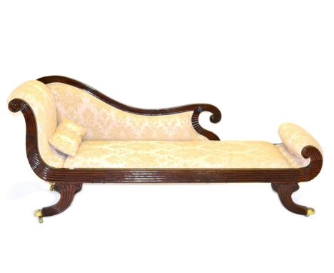 A Regency Style Mahogany Scroll End Sofa, 20th century, covered in beige floral damask with a reeded frame, raised on four sa