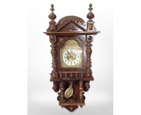 An early 20th century walnut eight day wall clock in bobbin turned case, height 100 cm
