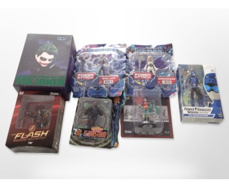 Seven Mattel, Toybiz and other figurines including Batman, He-Man, the Flash, etc., boxed.