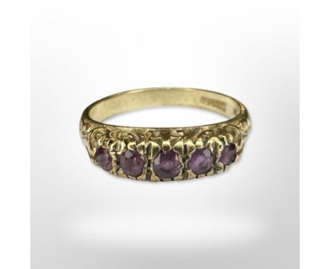 A 9ct yellow gold five stone  ruby ring, size L. CONDITION REPORT: 2.9g.