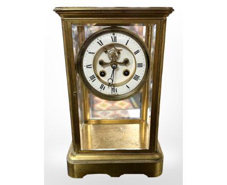 A French gilt brass and bevelled glass 8-day mantel clock, striking on a bell with Mercury pendulum, the white enamel dial wi