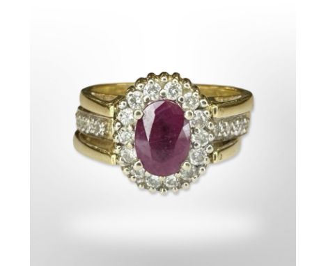 A yellow gold ruby, sapphire and diamond cluster revolving ring, size L/M. CONDITION REPORT: 10.9g. The shanks stamped 14ct a