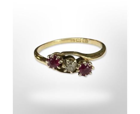 An 18ct yellow gold two stone ruby and diamond ring, size N. CONDITION REPORT: 2g.