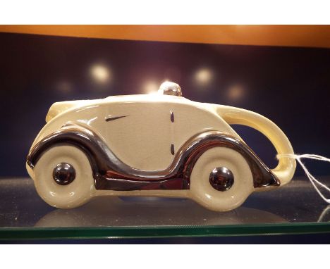A ceramic Sadler design 'Racing Car' teapot with highlights  OKT42