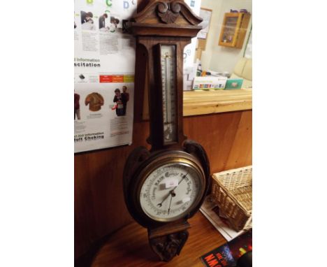 An oak cased barometer and thermometer 