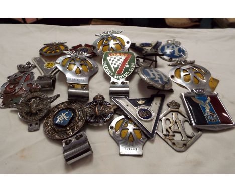 A large selection of automobile club chrome car badges