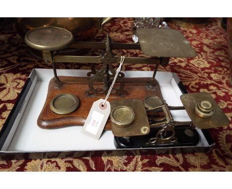 Two sets of antique brass and wood postal scales with weights 