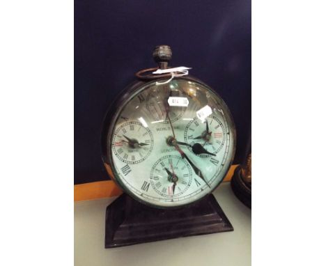 A novelty time piece and compass in the form of a large pocket watch