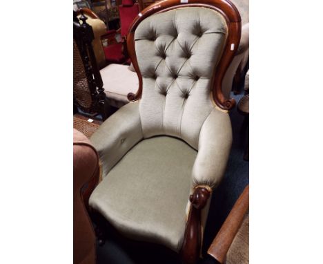 A mahogany framed scrolled and button-back nursing chair having green upholstery